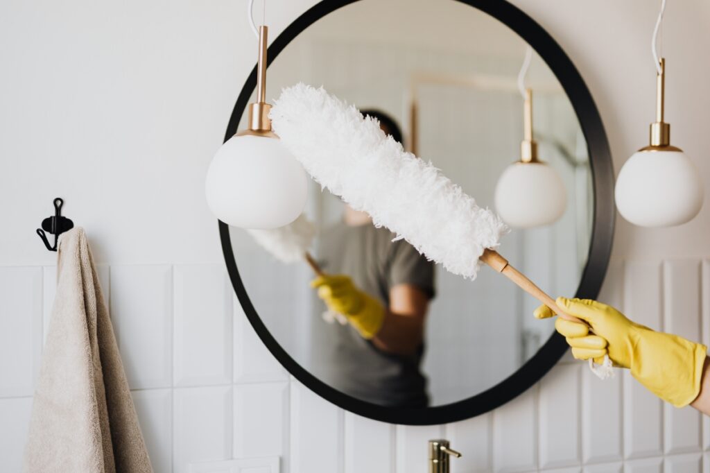 a man cleaning a window in one of the House Cleaning Services Near me