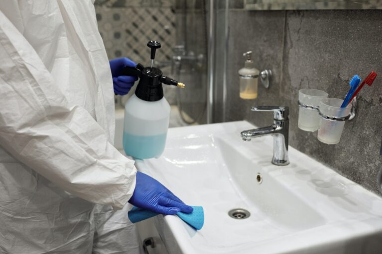 A cleaner cleaning a toilet sink